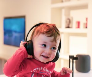 A photo of a toddler listening to headphones