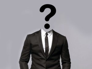 A person wearing a suit has a question mark for their head